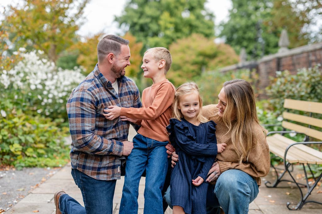 Kids in comfortable layered fall outfits with parents during an outdoor Pittsburgh family photo session